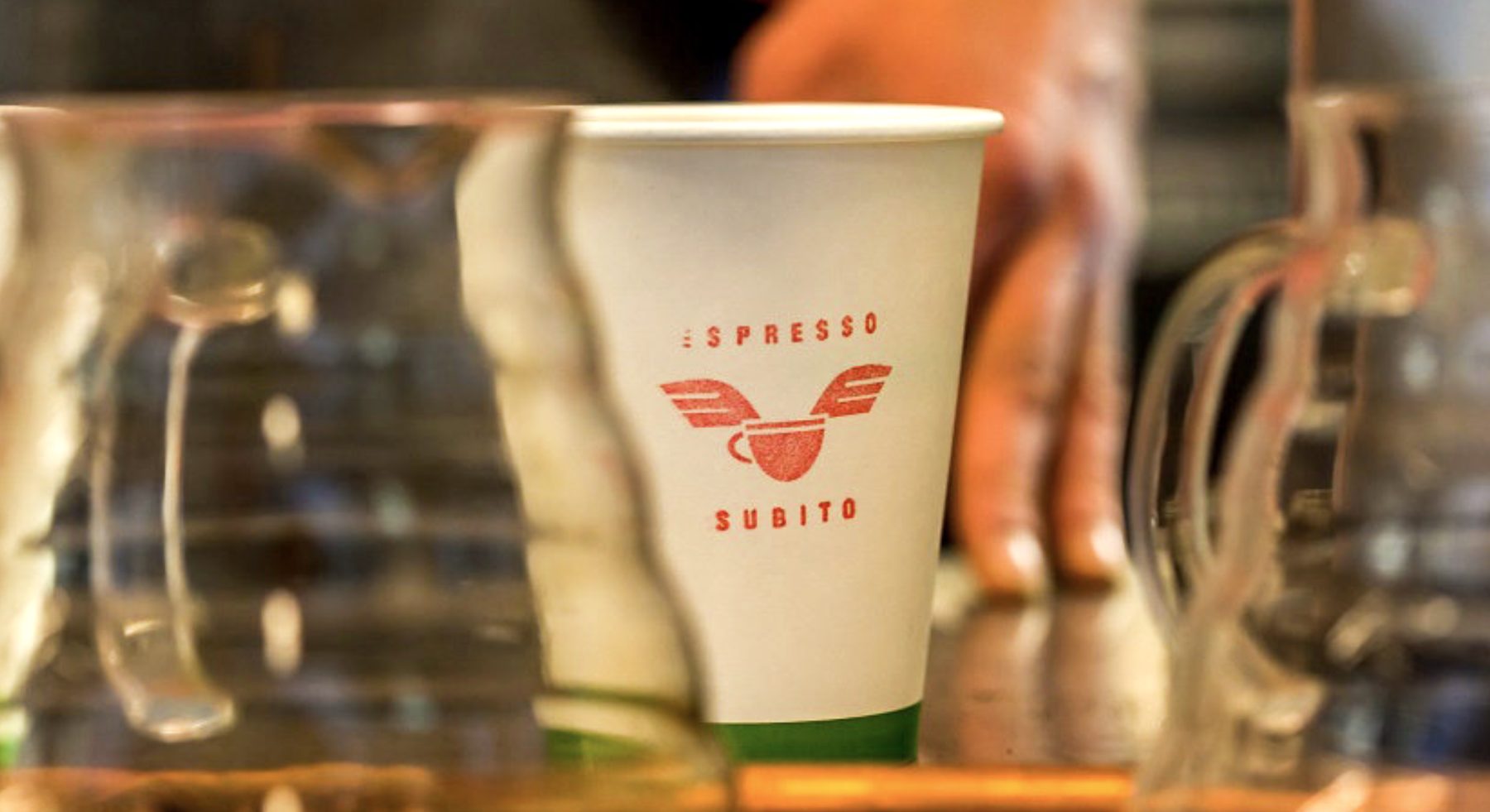 A cup branded with a client logo at an Espresso Subito event