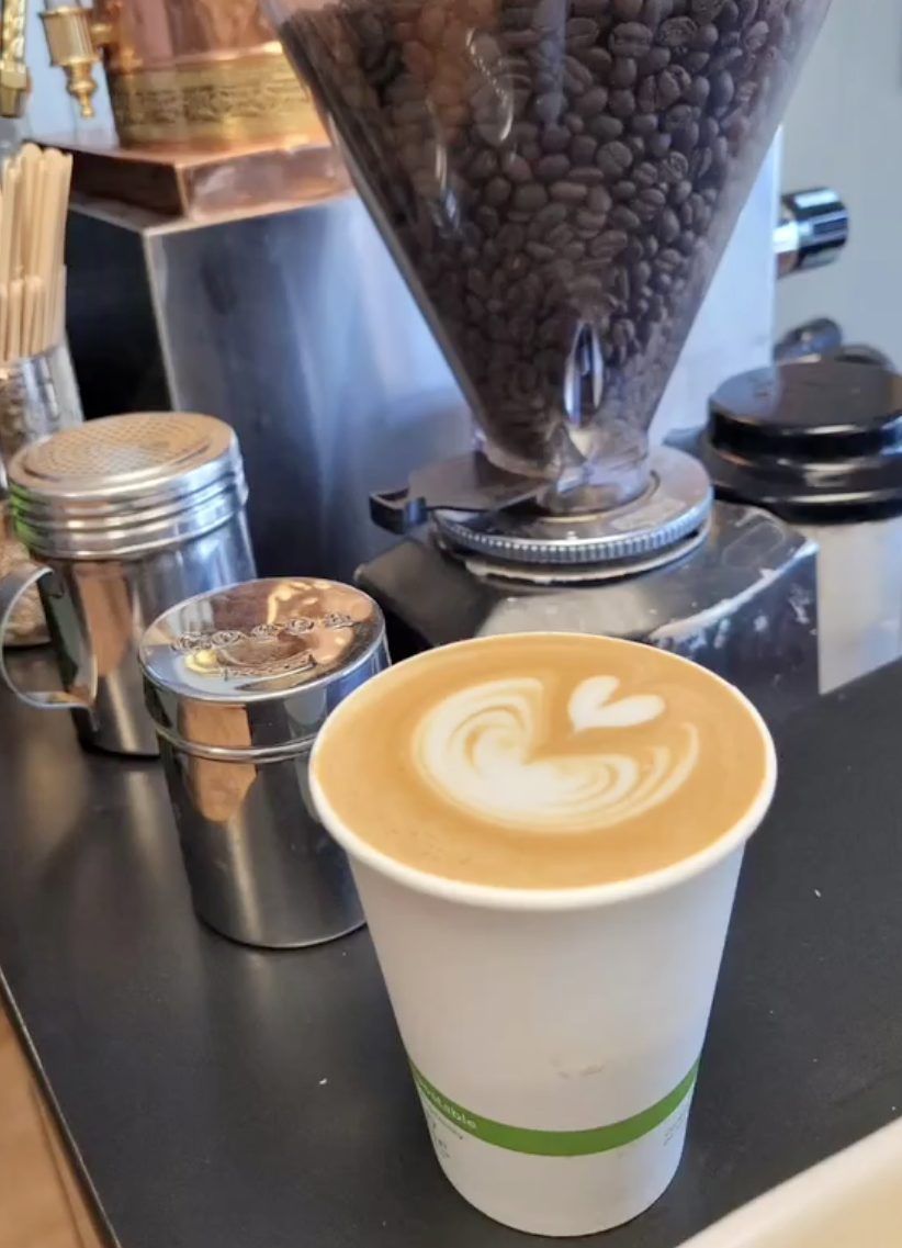 A freshly poured latte with rosetta art at the bar