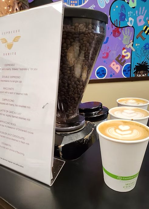 The Espresso Subito menu board beside fresh to-go lattes